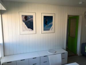 a white room with three pictures on the wall at Spacious house in Tromsø, perfect for groups of families, tourists or workers in Tromsø +60 photos