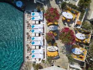 an overhead view of a resort with tables and chairs and a pool at Belvedere Mykonos - Main Hotel in Mýkonos City