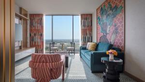 オーランドにあるLake Nona Wave Hotelのリビングルーム(ソファ、椅子、大きな窓付)