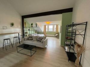 a living room with a white couch and a table at City-Wohnen in Düren im Boho-Style in Düren - Eifel