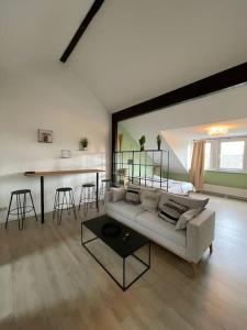 a living room with a white couch and a table at City-Wohnen in Düren im Boho-Style in Düren - Eifel