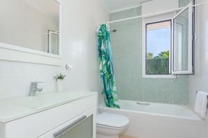 a bathroom with a toilet and a sink and a window at Binicasal in Sant Lluis +19 photos