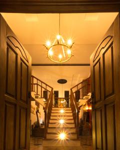 a hallway with a staircase with a chandelier at Room in BB - Kilihouse Bb Large Ensuite Double Bedroom in Thika