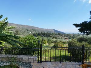 a black fence with a view of a mountain at Villa Dimitris in Kalamitsi Amygdali