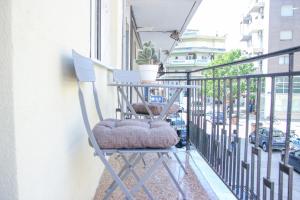 a chair on a balcony with a plant at CasaTu Αpartments in Komotini