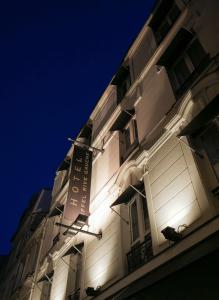 a white building with a sign on the side of it at Hôtel Eiffel Rive Gauche in Paris