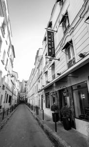 a black and white photo of a street with buildings at Hôtel Eiffel Rive Gauche in Paris