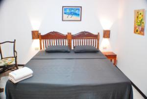 a bedroom with a large bed with two pillows on it at Blue Coral Resort Boracay in Boracay