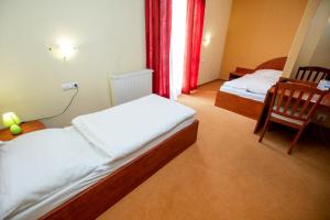 Postel nebo postele na pokoji v ubytování Hotel Boss