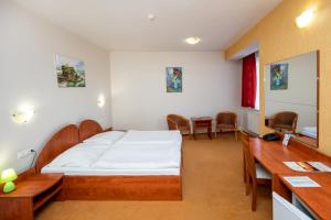 Postel nebo postele na pokoji v ubytování Hotel Boss
