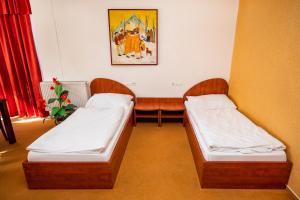 Postel nebo postele na pokoji v ubytování Hotel Boss