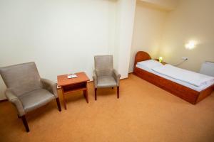 Postel nebo postele na pokoji v ubytování Hotel Boss