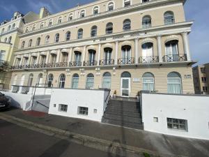 a large building with stairs in front of it at OYO Gran Canaria Hotel in Folkestone