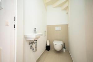 mała łazienka z umywalką i toaletą w obiekcie OrestaLiving - Penthouse with designer renovation w Wiedniu +12 zdjęć
