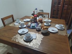 un tavolo in legno con piatti e stoviglie di Uriburu B&B a Resistencia