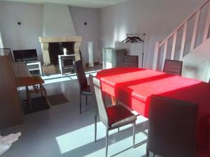 a living room with a red table and chairs at Domaine de gentilly la maison 