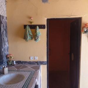 a bathroom with a sink and a red door at desert Feeling in Mhamid