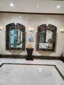 a room with three mirrors on the wall at Furnished Studio apartment near Business Bay Metro Station in Dubai