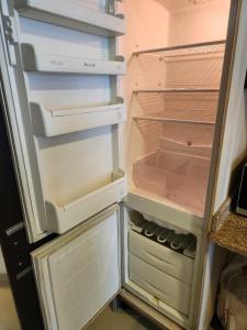 an open refrigerator with its door open and its at Furnished Studio apartment near Business Bay Metro Station in Dubai
