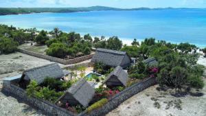 een luchtzicht op een huis met bloemen en de oceaan bij Loedi Bungalows Rote in Nembrala