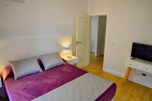 a bedroom with a large bed and a television at Leo Canela in Isla Canela