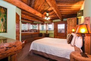 a bedroom with a bed in a room with wooden ceilings at Chipeta Lodge in Ridgway +94 photos