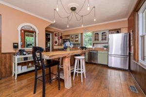 a kitchen with a wooden table and a refrigerator at Bohemian Room in a 150-Year-Old Victorian House in Orangeville