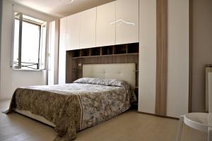 a bedroom with a bed and white cabinets at Emerenziana Lovely Apartment in Rome