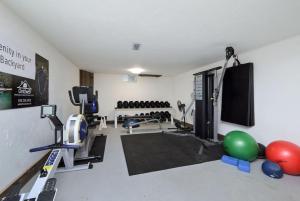 a fitness room with a gym with balls and weights at Bohemian Room in a 150-Year-Old Victorian House in Orangeville