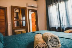 Postel nebo postele na pokoji v ubytování Boho's Hotel