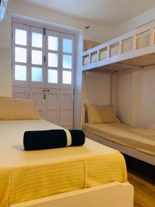 two beds in a room with two bunk beds at Marquito's Guest House in Panaji