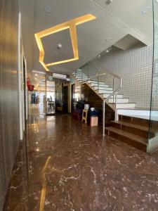 a lobby with a staircase in a building at Hotel Pearl View - Near US Embassy BKC in Mumbai