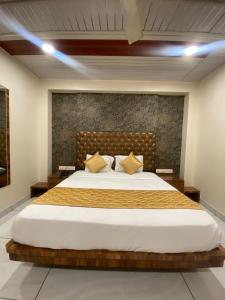 a bedroom with a large bed in a room at Hotel Pearl View - Near US Embassy BKC in Mumbai