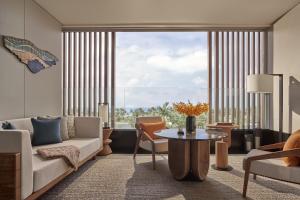 a living room with a couch and a table at Regent Phu Quoc in Phu Quoc