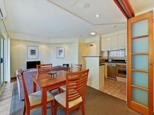 a kitchen and dining room with a wooden table and chairs at The Sedgebrook On Leichhardt in Brisbane