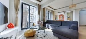 a living room with a couch and a table at Galata Abraham by NewInn in Istanbul