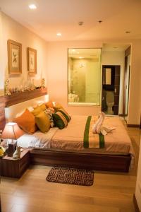 een slaapkamer met een groot bed en een grote spiegel bij 1b-design-50sqm-Astra-ChiangMai in Chiang Mai
