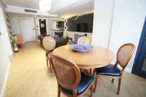 a dining room with a wooden table and chairs at Mitte Port Hotel Konak Izmir in Izmir