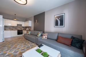a living room with a couch and a kitchen at Luxury in City -8- Free Parking in Łódź
