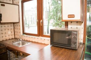 a microwave sitting on a counter in a kitchen at Archimede Guest House in Brussels +21 photos