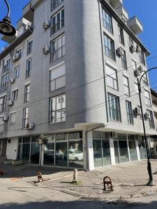 a large gray building with windows and a street light at Big Apartment with private parking - EXTRA VIEW in Skopje