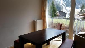 a black table in a room with a large window at Rosanna Sankt Anton in Sankt Anton am Arlberg