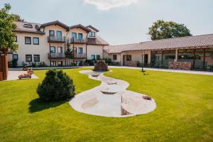 a yard with a large building and a grassy field at Hotel Birkenhof in Heidelberg