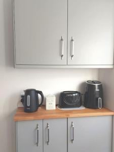 a kitchen counter with two toasters and a toaster at Comfortable 2 bedroom house in historic Exeter in Exeter