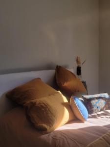 uma cama com quatro almofadas em cima em La Chambre du 21 em Trouville-sur-Mer