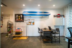 a room with a table and a surfboard on the wall at Quattro Briganti in Salerno