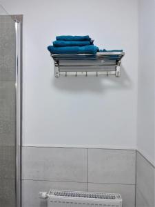 a towel rack with blue towels on it in a bathroom at Tante Emma Sydney in Paderborn