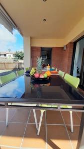 a table with a bowl of fruit on top of it at Villa Mediterránea con Cinco Dormitorios y Piscina in Calonge +40 photos
