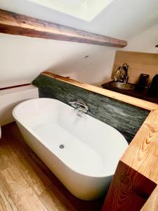 a bath tub in a bathroom with a sink at delille pere et fils in Albertville