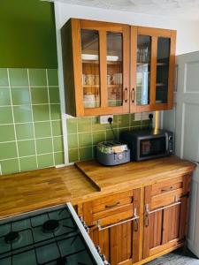 a kitchen with a counter top with a microwave at Goldcroft in Abertillery
